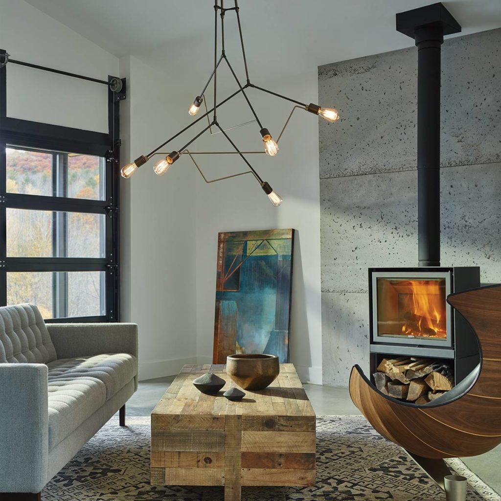 A beautiful chandelier from Hubbardton Forge lights.