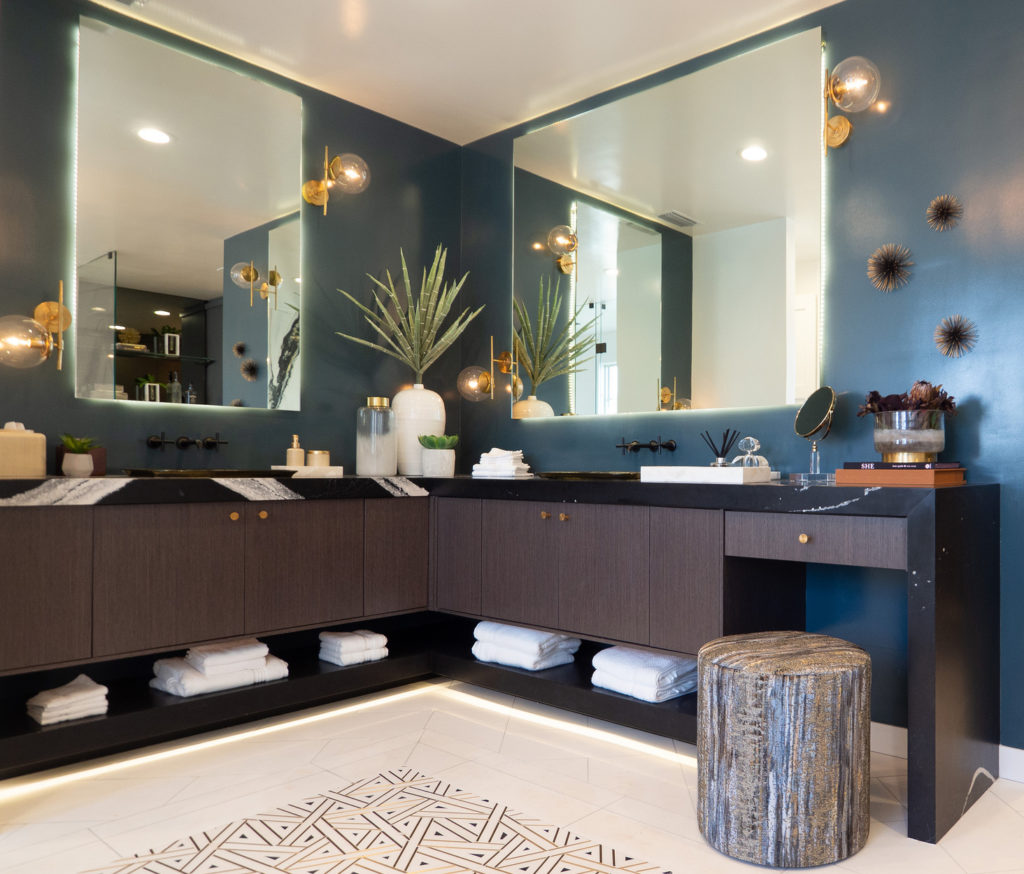 bathroom with LED lighting strips behind the mirrors and under-foot of the bathroom cabinets