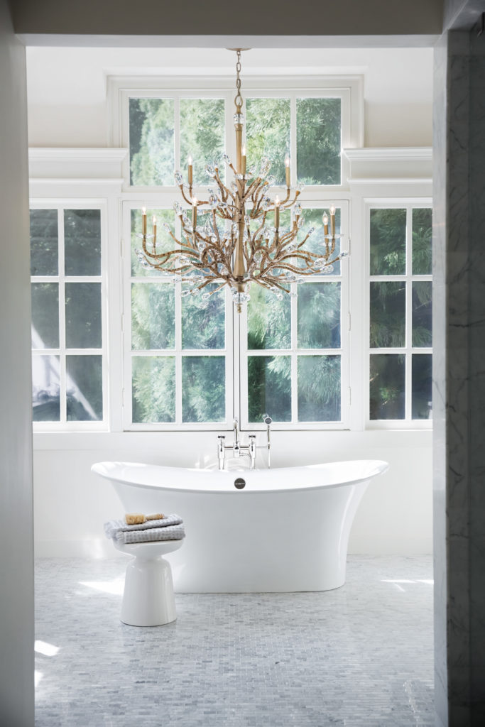 The Eve 48-Inch Chandelier is a soft gold pendant light that feels soothing over a white soaker tub