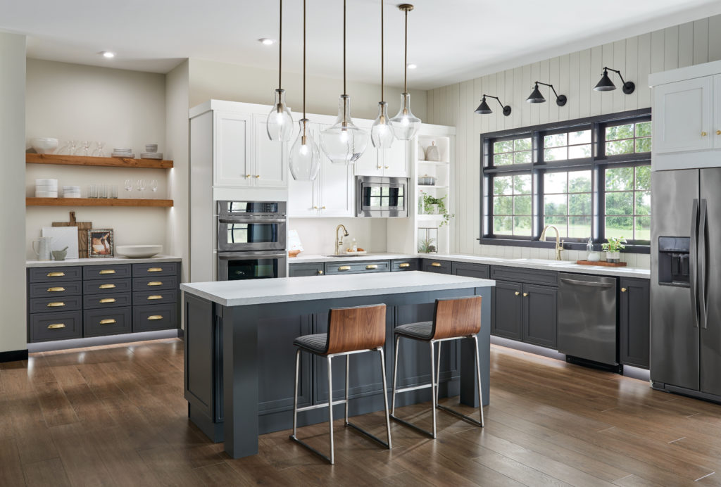 5 different shapes from the Everly Collection by Kichler Lighting hang above a gray-blue kitchen island