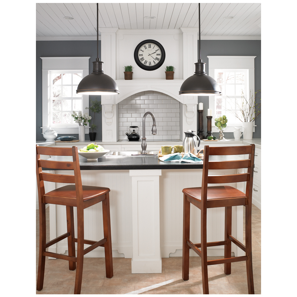 The Pratt Street Pendant's classic shape complements a white wood kitchen island with intricate trimming