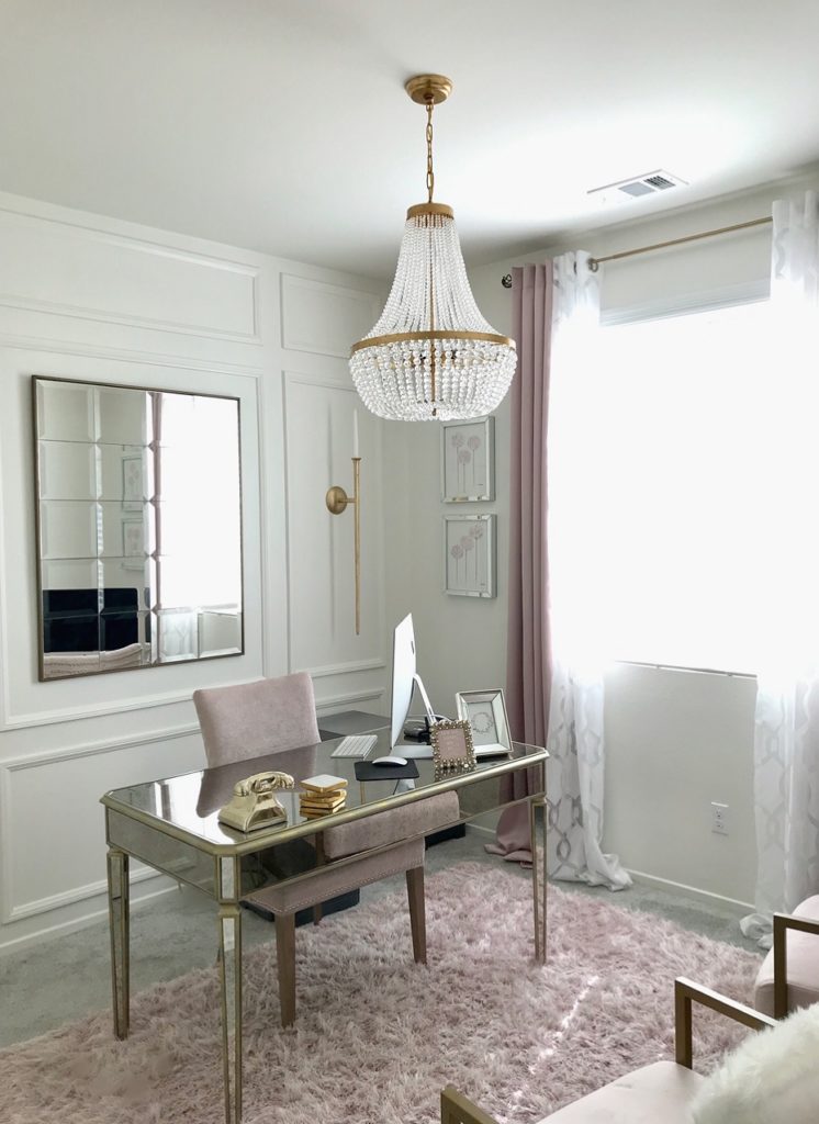 The Rylee 18 Inch Chandelier by Crystorama reflects natural light from the window down over a mirrored desk