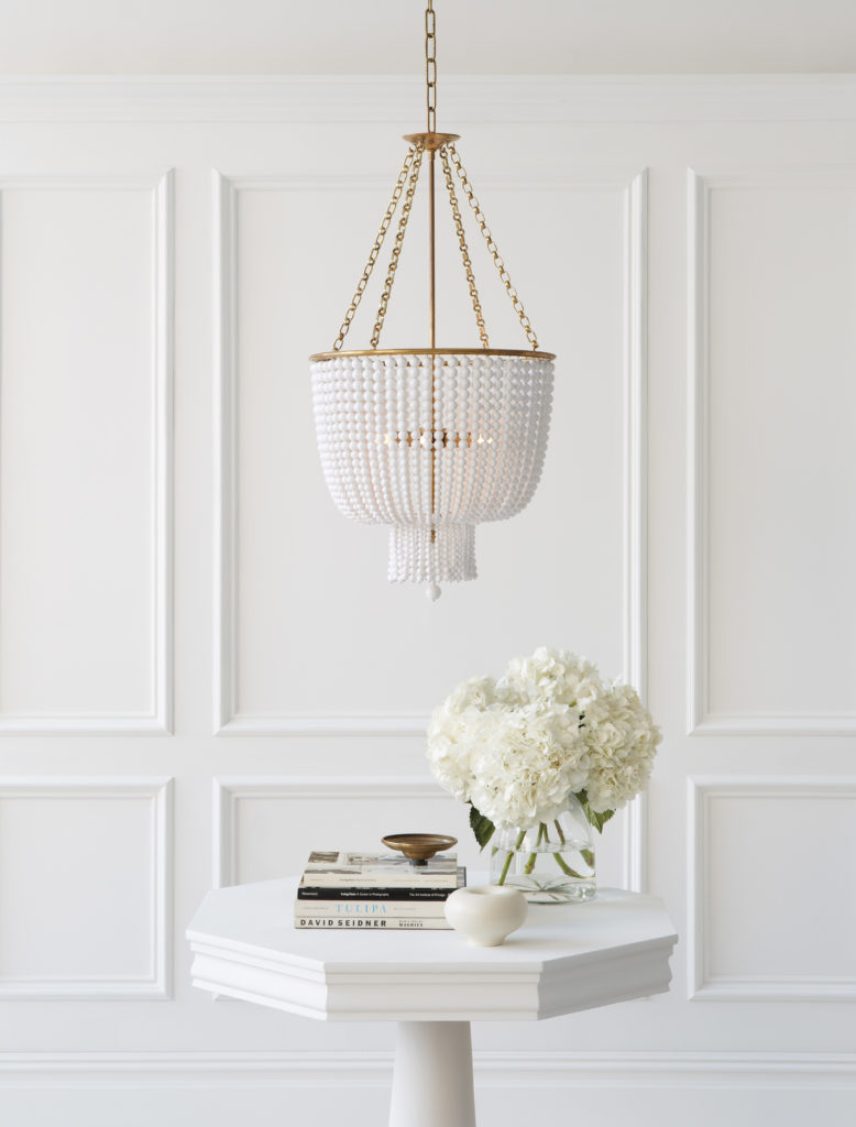 An abstract Aerin Jacqueline pendant, made with acrylic white beading and a soft brass finish.