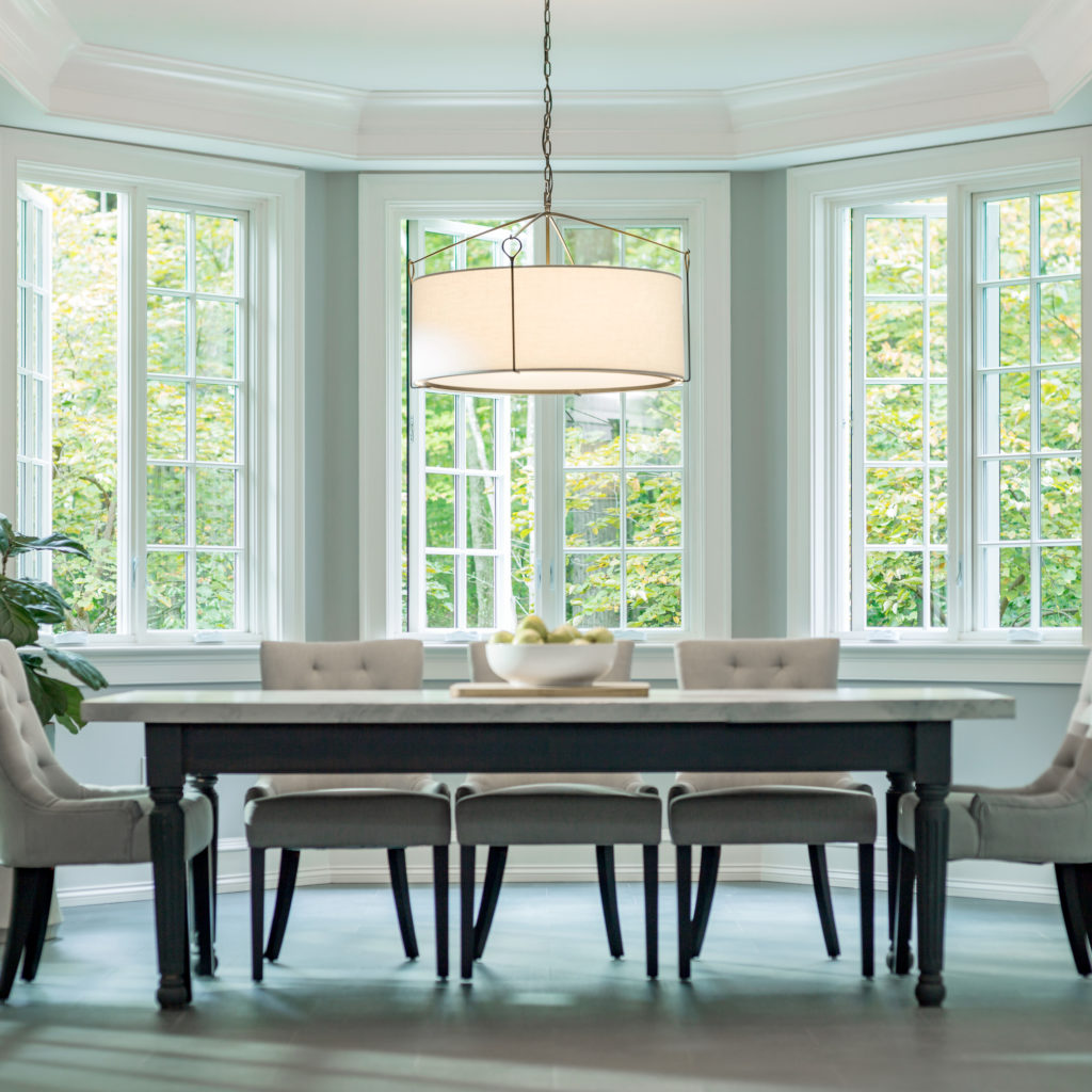 The Bow Pendant is the perfect modern dining room lighting in this neutral dining space