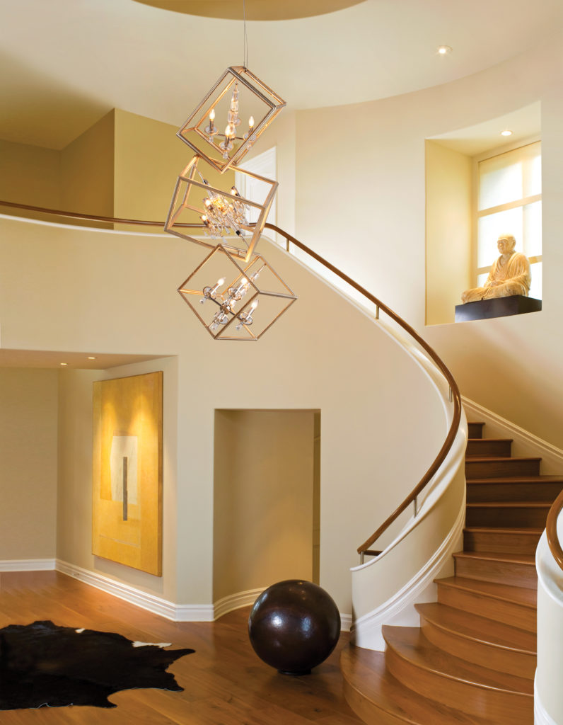 The Houdini Cage Pendant is a magical display in a neutral-tone, minimalist foyer