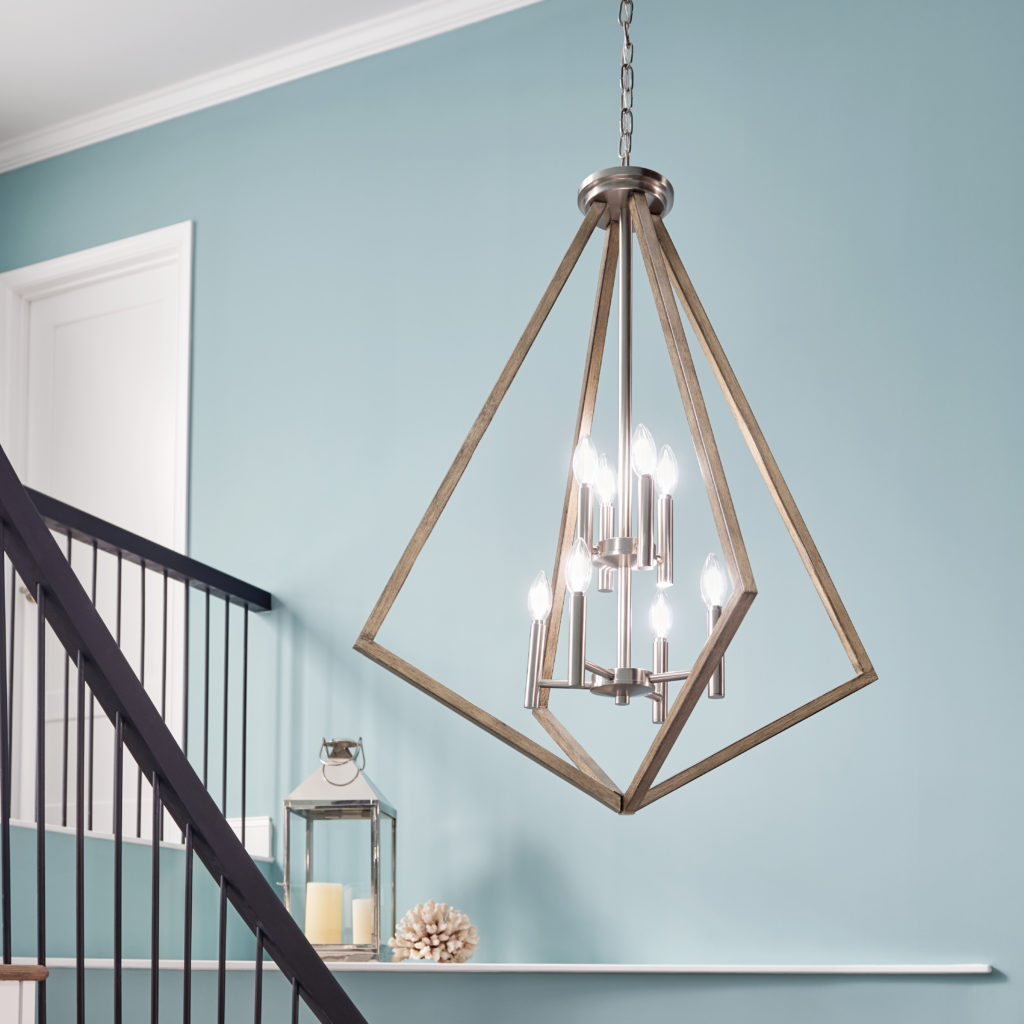 A closeup of the Deryn Chandelier shows the distressed gray finish complements a blue wall color