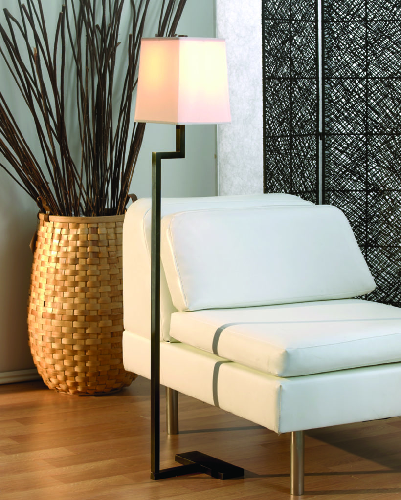 The classic minimalist Doughnut Floor Lamp features a cutout design that hugs a straight-edged chair.