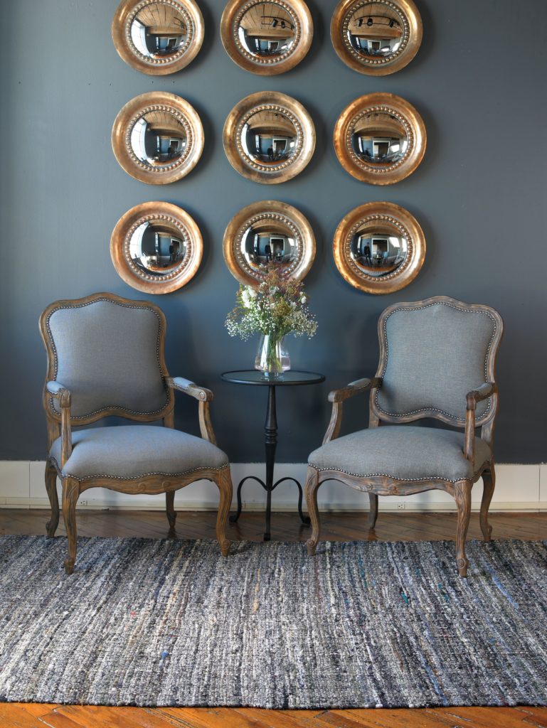 9 Copper Tropea Rounds Wall Mirrors hang in three rows like a decorative gallery wall