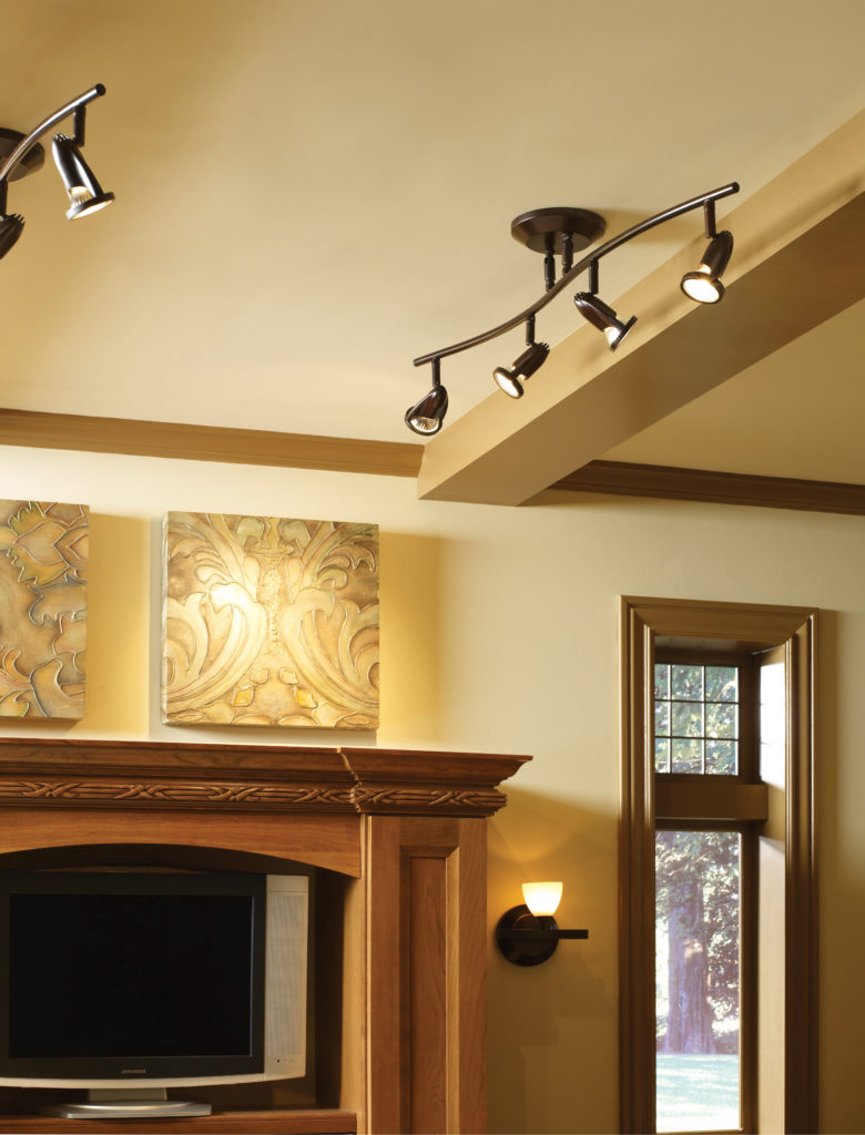 Agron track lighting in bronze is both functional and stylish in this warm-toned media room | Capitol Lighting