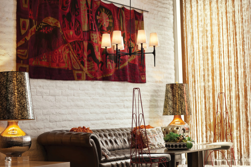 The Beaumont chandelier’s traditional shape and modern accents pair with this eclectic living space | Capitol Lighting