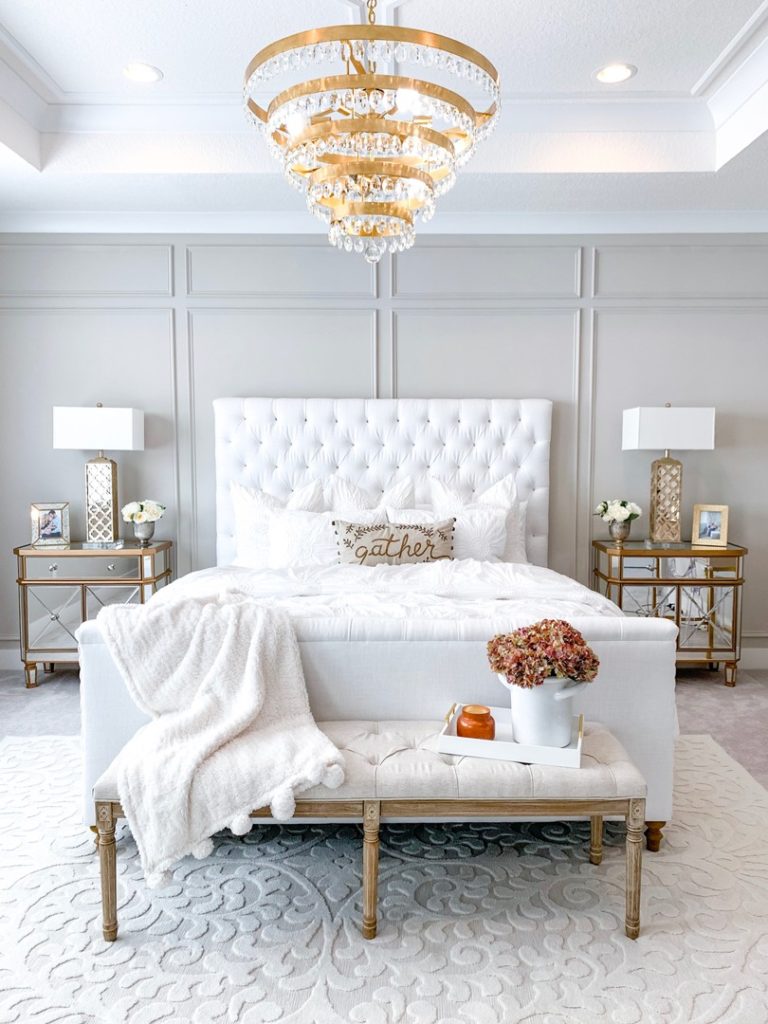 Perla Chandelier by Crystorama hangs in the center of a white modern-glam master bedroom | Capitol Lighting