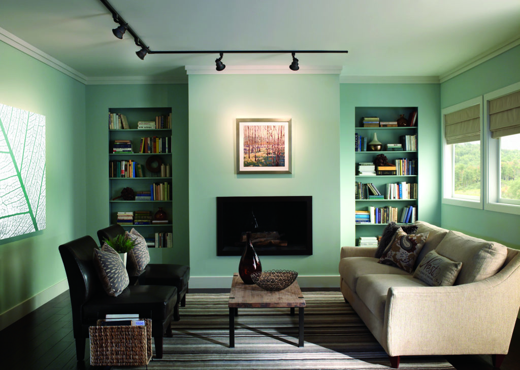 L-shaped Rialto track light highlights a picture on the wall in this cool, relaxed living room | Capitol Lighting
