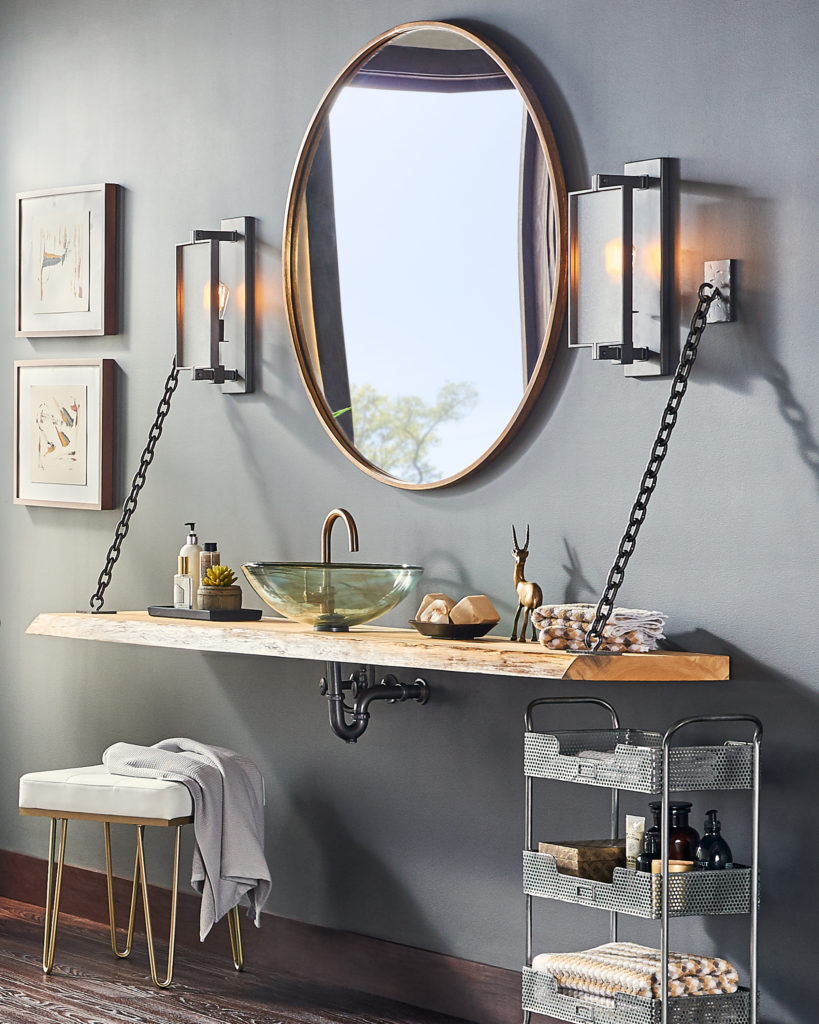 The Feiss Dailey Wall Sconce blends in with a rustic wood vanity and sleek mod accessories.