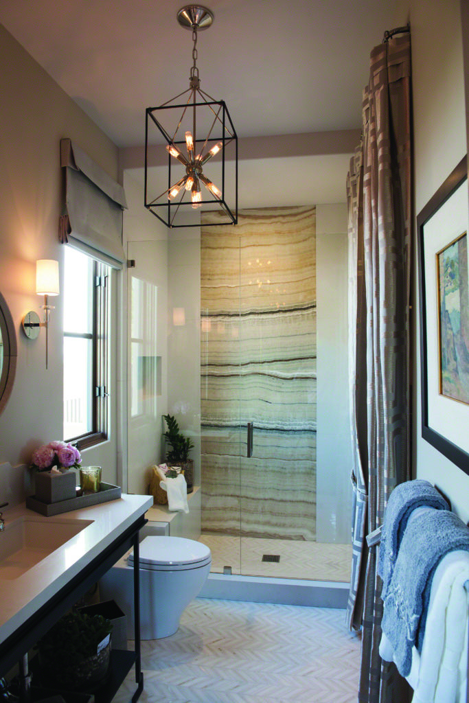 The Glendale Cage Pendant’s sputnik-style core sends warm light throughout this modern bathroom.