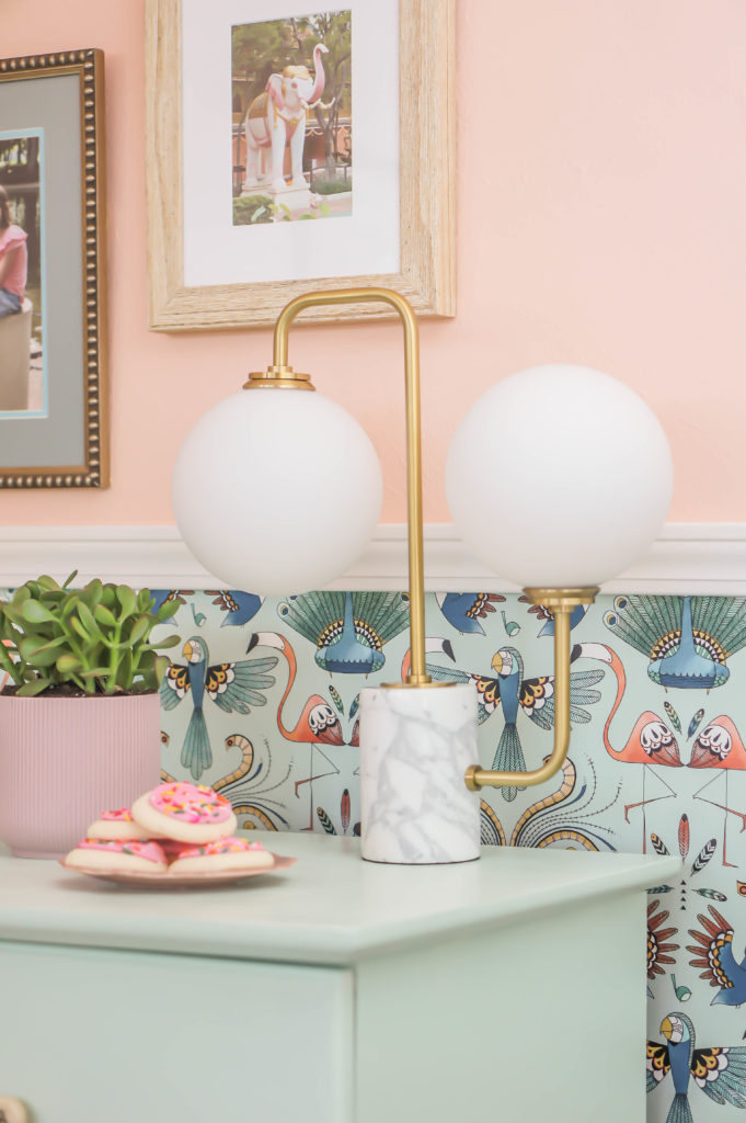 The modern, geometric Mia table lamp matches quirky flamingo wallpaper and seafoam green dresser.