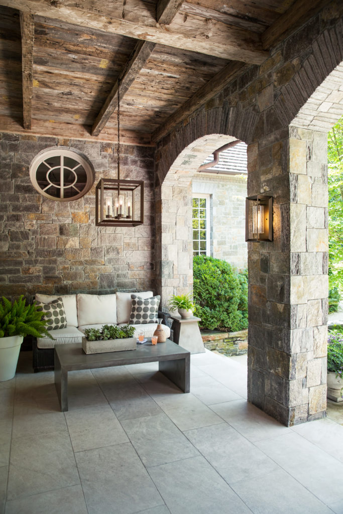 Rhodes Hanging Lantern and Wall Light prove that outside lantern lights can brighten a stone patio.