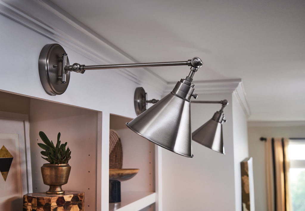 With its articulating arm, the Arti wall sconce adds industrial decor to built-in bookshelf. 