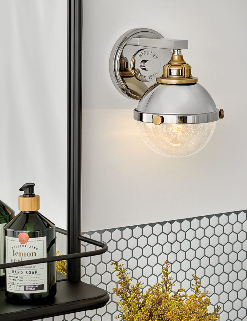 The Fletcher wall sconce is a small taste or industrial decor in a modern bathroom.