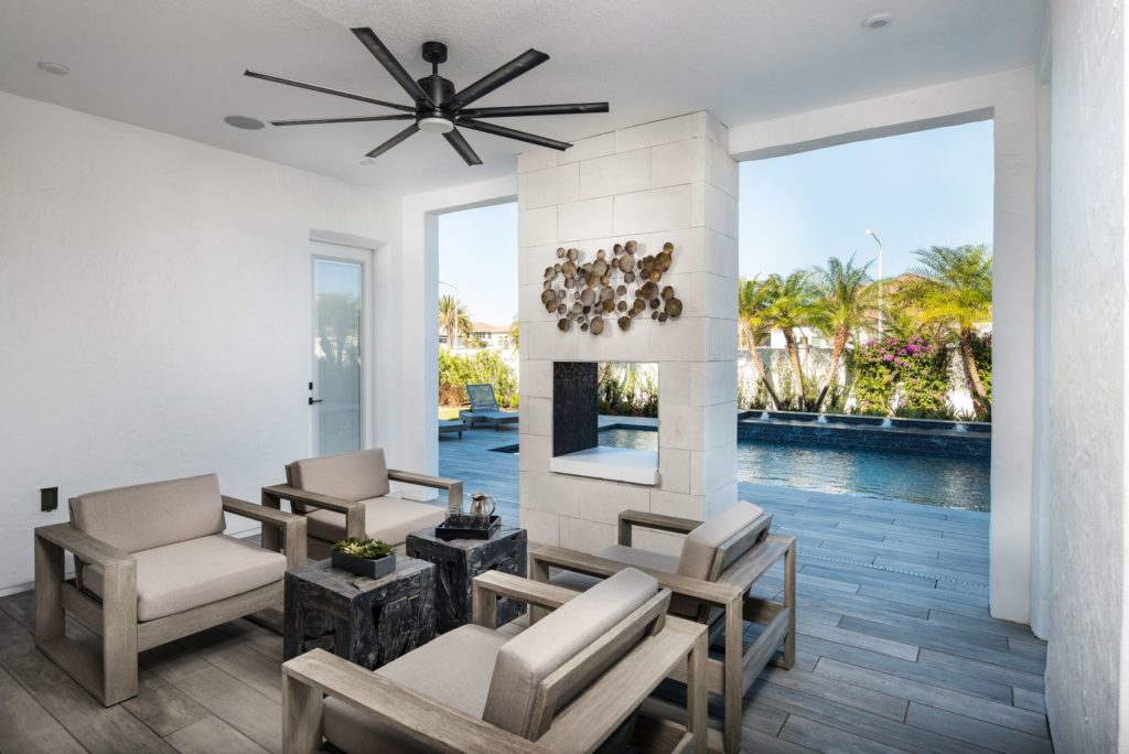 With eight sleek black blades, the Vast outdoor ceiling fan keeps tropical pool patio nice and cool.