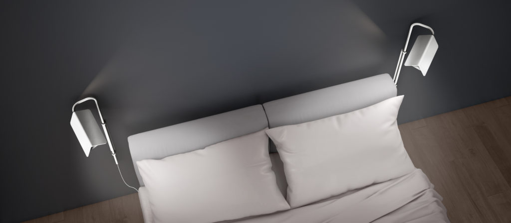 Two Morii wall swinging lamps on each side of a bed.