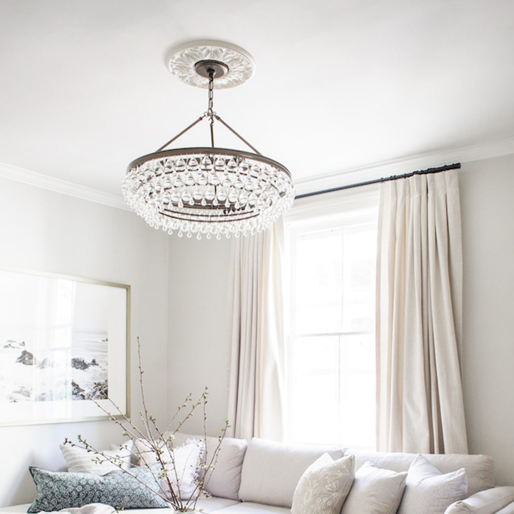 Calypso crystal chandelier works as living room lighting in a soothing neutral space. 