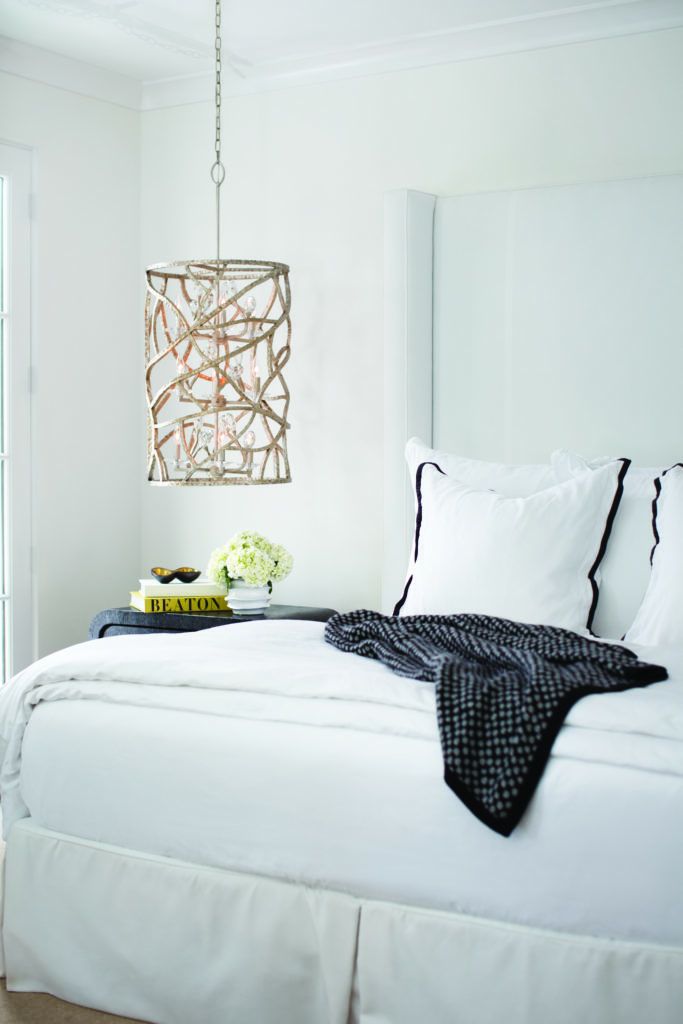 The Eve pendant light adds beach themed decor to a light-and-airy bedroom.