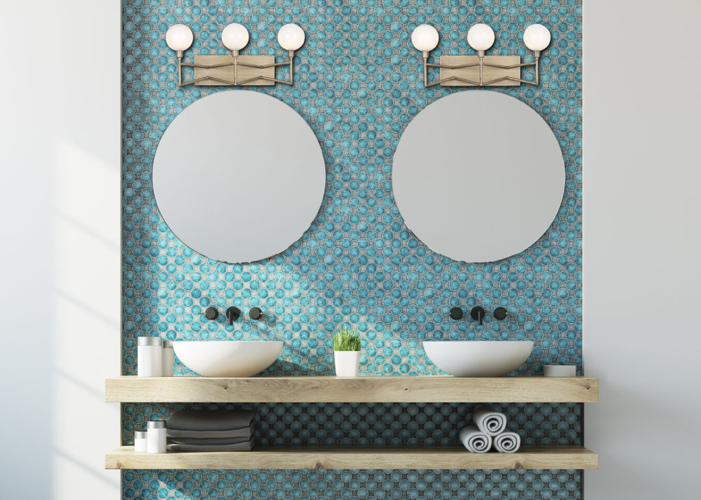 A Varaluz Bodie Light Bath and Vanity Sconce above two bathroom mirrors.