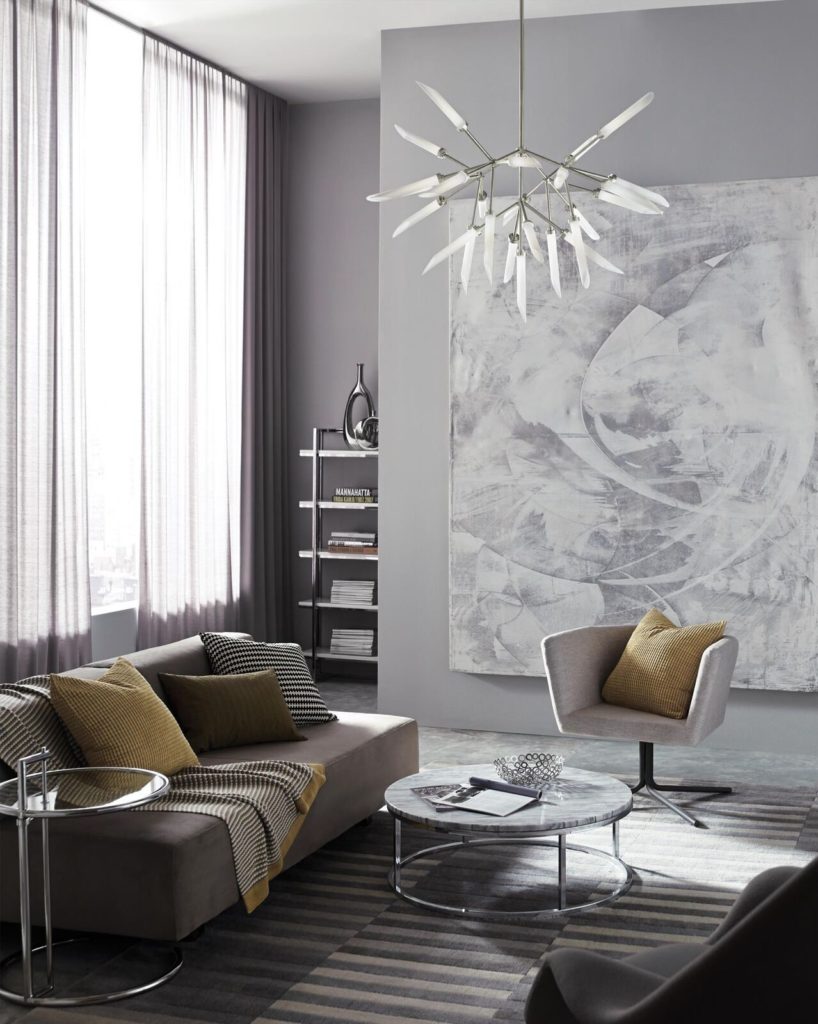 With its 25 frosted edges, the Spur chandelier is a modern sculpture in a minimalist living room.